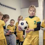Young Blonde Female Soccer Player Girl during football training